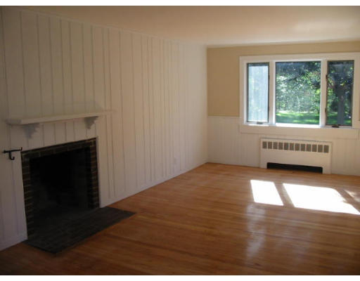 16 Grosvenor Road Needham, MA 02492 - Photo 5 of 7 a view of an empty room with wooden floor and a fireplace