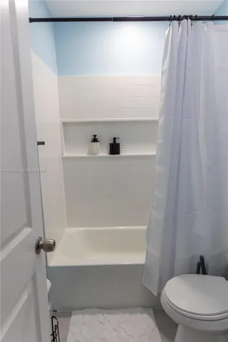 a bathroom with a bathtub and a toilet