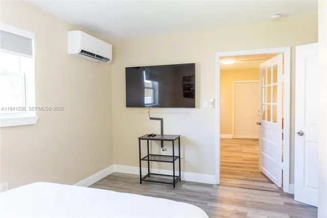 a bedroom with a bed and a flat screen tv