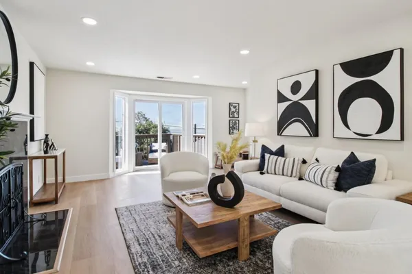 a balcony with wooden floor table and chairs
