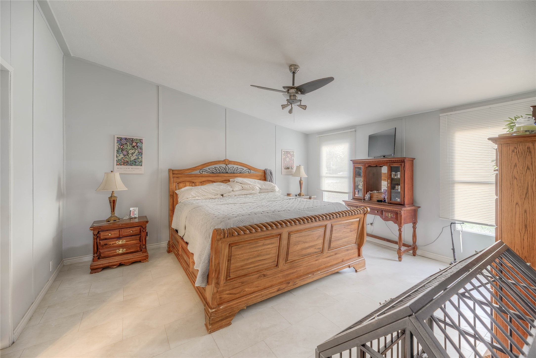 17709 Pine View Drive Conroe, TX 77302 - Photo 19 of 26 a bedroom with a bed and a chandelier