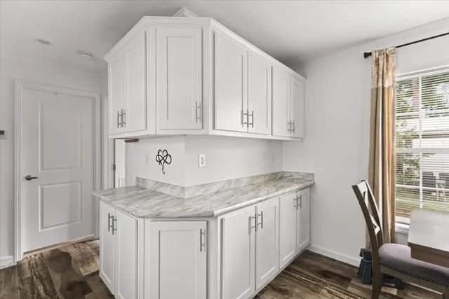 a view of cabinets a wooden floor and a window