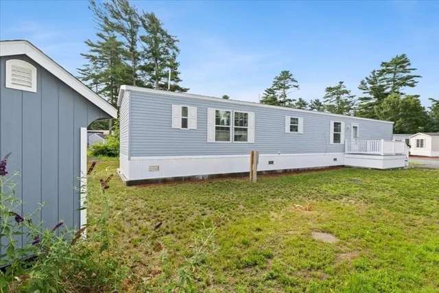 a backyard of a house with wooden floor and fence