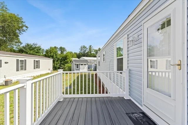 a view of a house with wooden deck