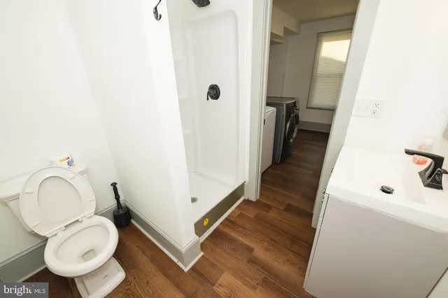 a bathroom with a toilet a sink and a mirror