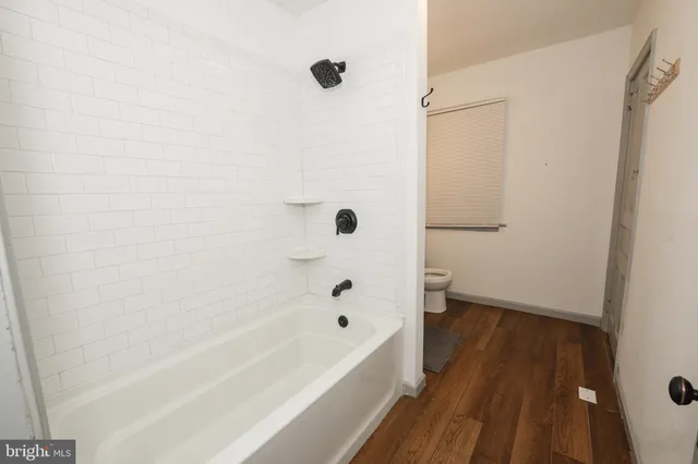 a bathroom with a bathtub and shower