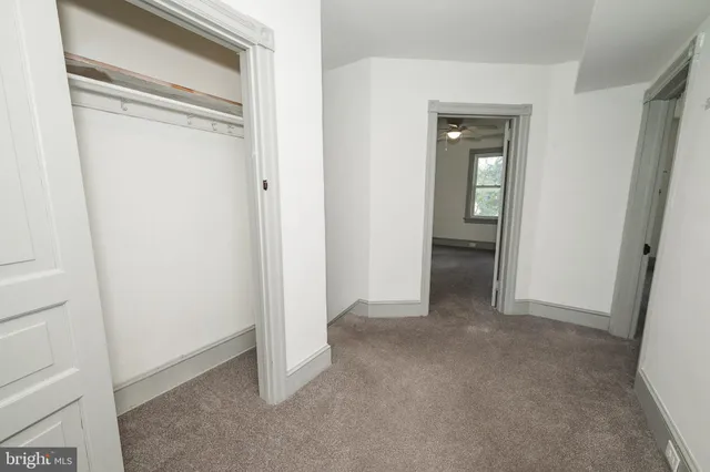a view of an empty room and closet