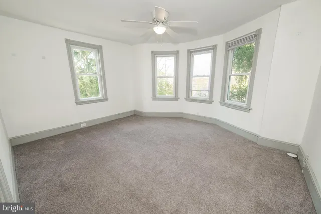 an empty room with windows and closet