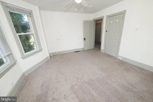 an empty room with windows and entrance