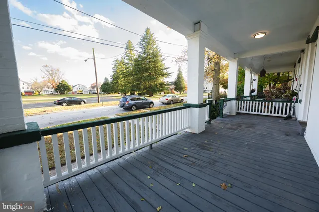 a view of a porch with wooden floor