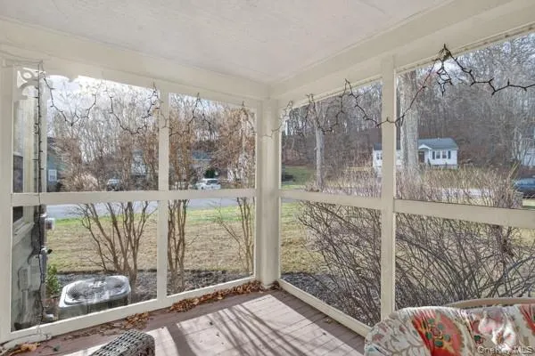 a view of a porch with a floor to ceiling window