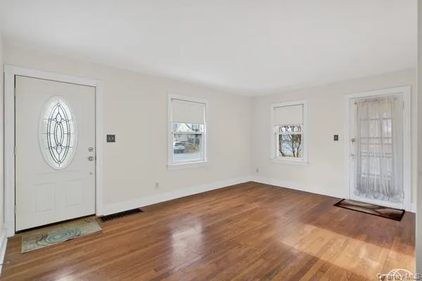 an empty room with windows and closet