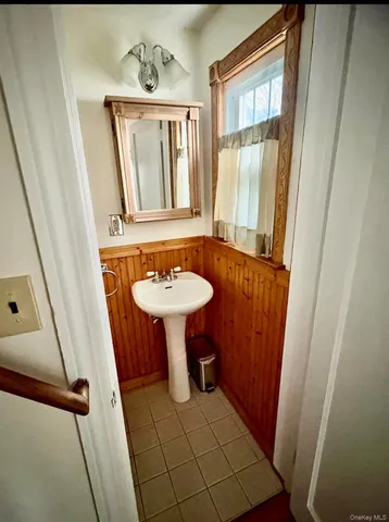 a bathroom with a sink a mirror and a shower