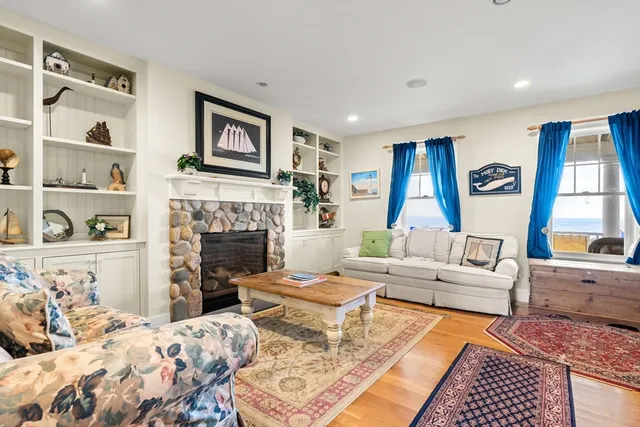 a living room with furniture fireplace and window