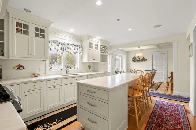 a kitchen with granite countertop a sink and cabinets