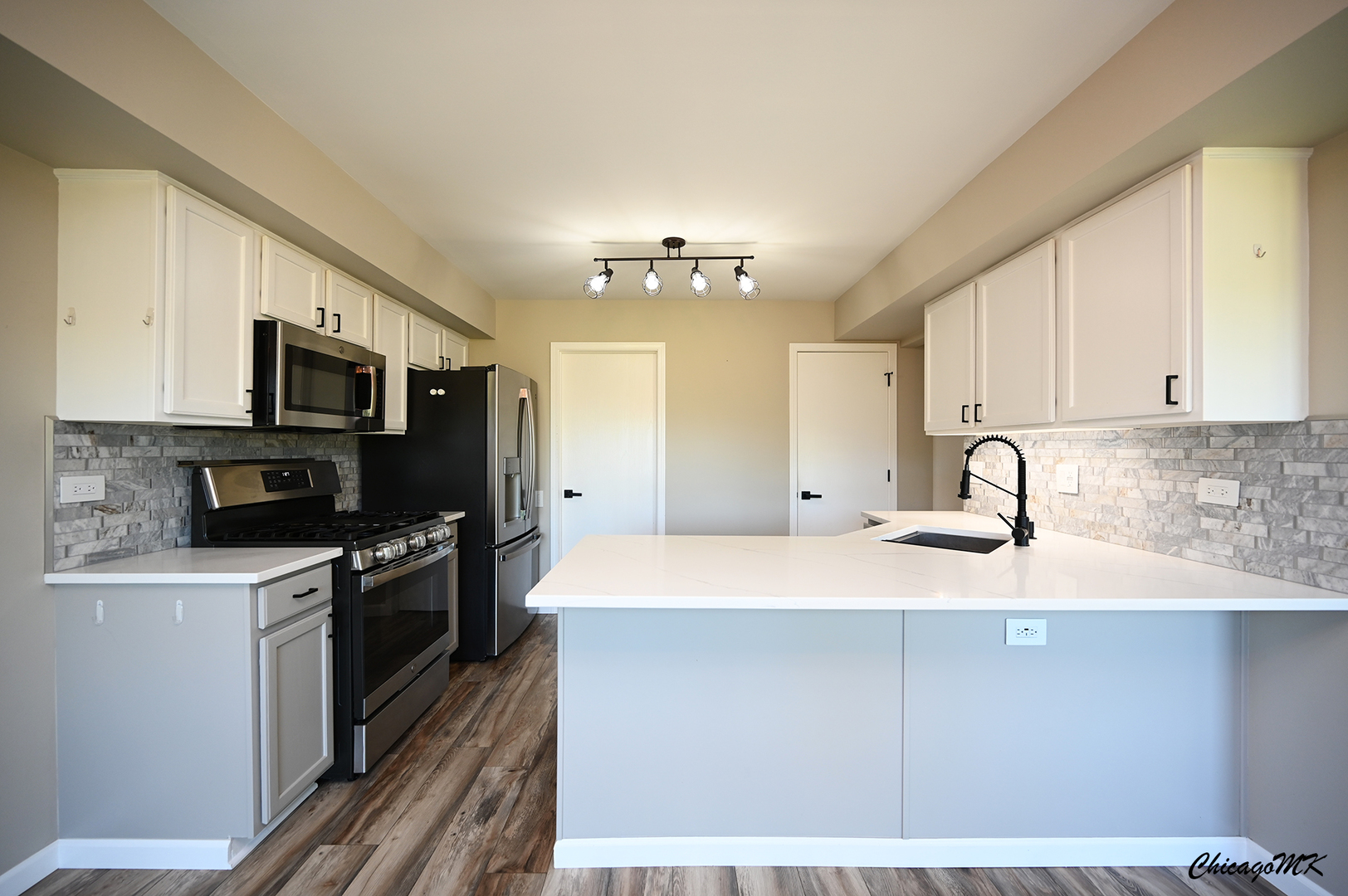 425 Locksley Drive Streamwood, IL 60107 - Photo 11 of 48 a view of a kitchen with kitchen island a sink stainless steel appliances and cabinets