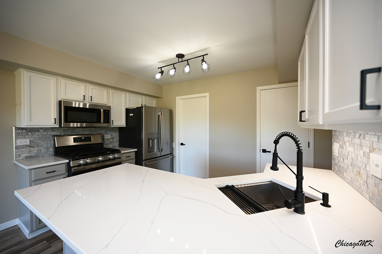 425 Locksley Drive Streamwood, IL 60107 - Photo 12 of 48 a kitchen with stainless steel appliances a sink a stove a microwave and cabinets