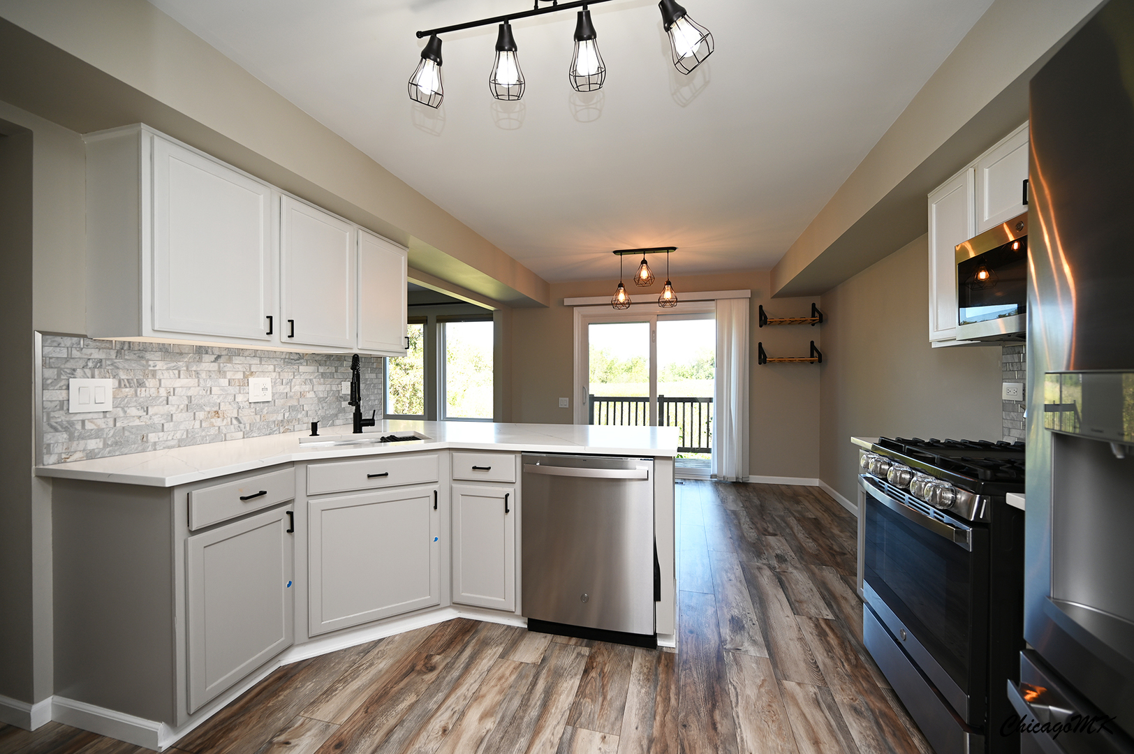 425 Locksley Drive Streamwood, IL 60107 - Photo 14 of 48 a kitchen with stainless steel appliances granite countertop a stove and cabinets