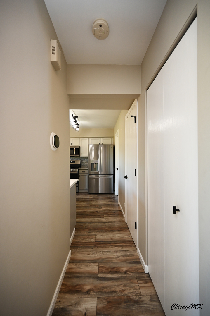 425 Locksley Drive Streamwood, IL 60107 - Photo 17 of 48 a view of a hallway with wooden floor and staircase