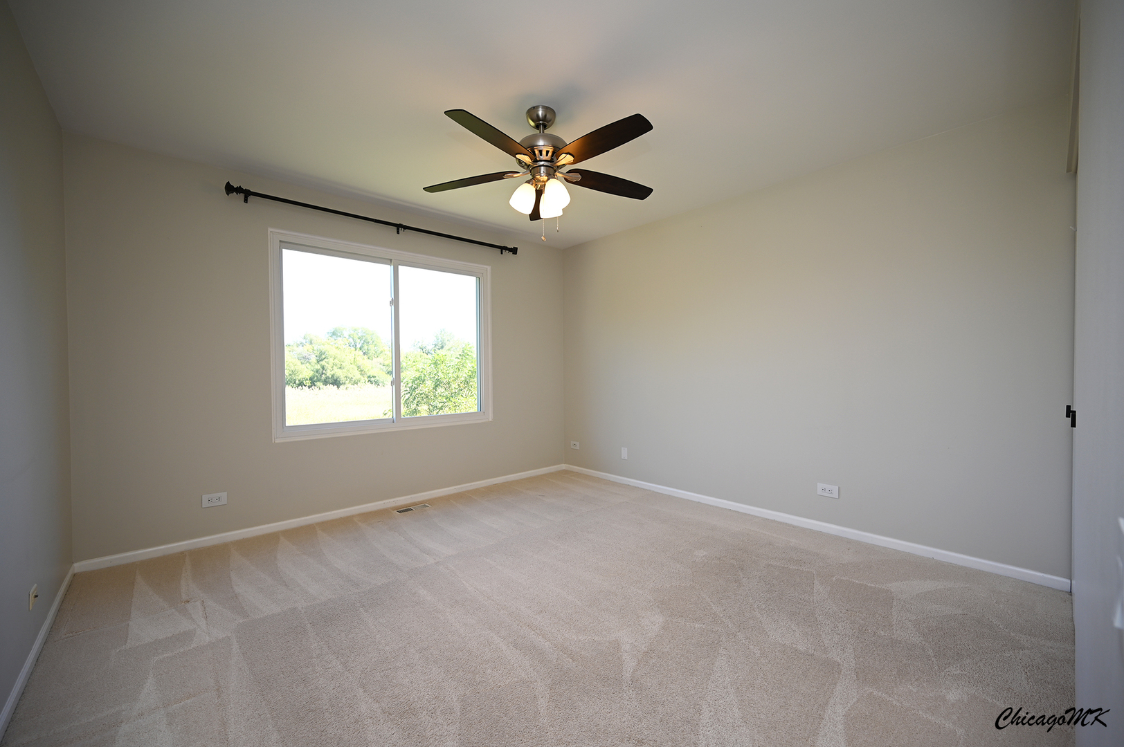 425 Locksley Drive Streamwood, IL 60107 - Photo 28 of 48 an empty room with a window and a fan