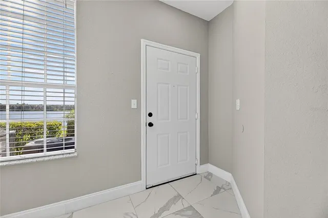 a view of an empty room with windows