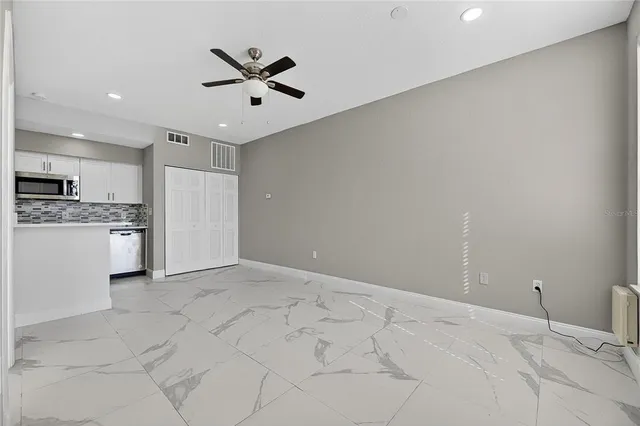 a view of a kitchen with a sink and a stove top oven
