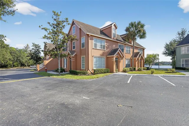a street sign under a large tree