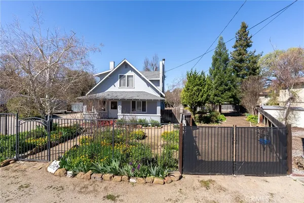 a front view of a house with a yard and fountain