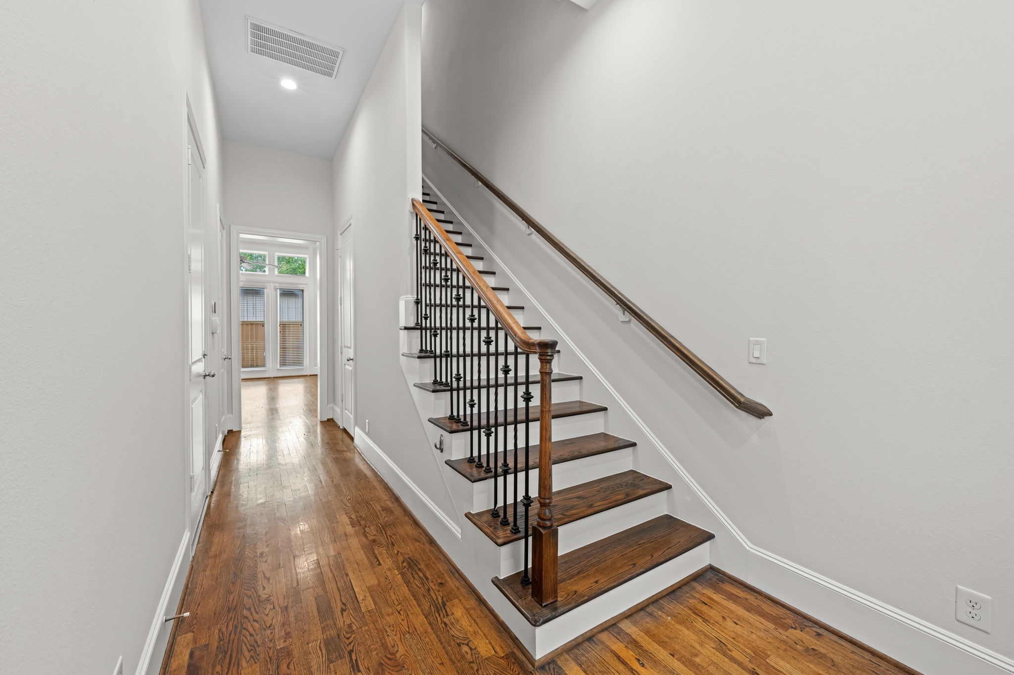 5621 Cohn Meadow Lane Houston, TX 77007 - Photo 10 of 35 Inviting entry with hardwood floors, high ceilings, and elegant staircase with wrought iron balusters.