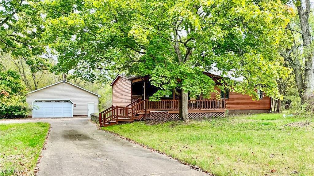 3 bedroom home with a 2 bedroom addition. Huge garage, shed, and 7 acres!