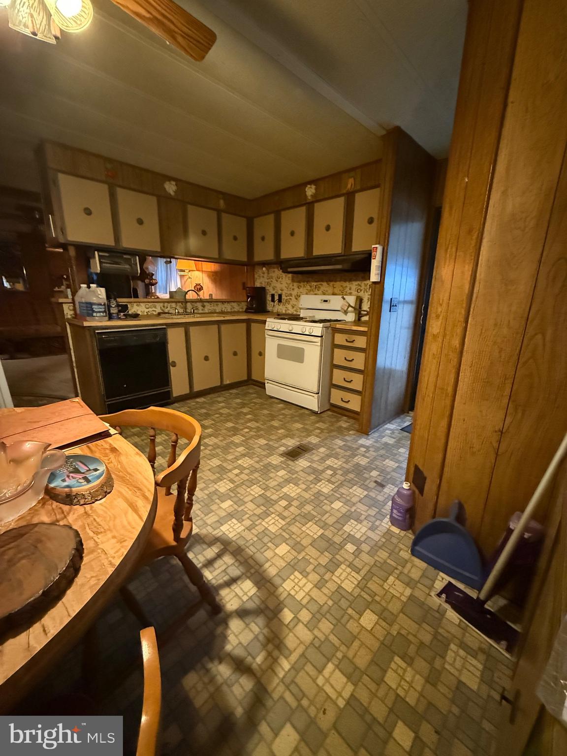 11493 Ross Lane Delmar, DE 19940 - Photo 5 of 10 a kitchen with a sink a stove top oven and cabinets