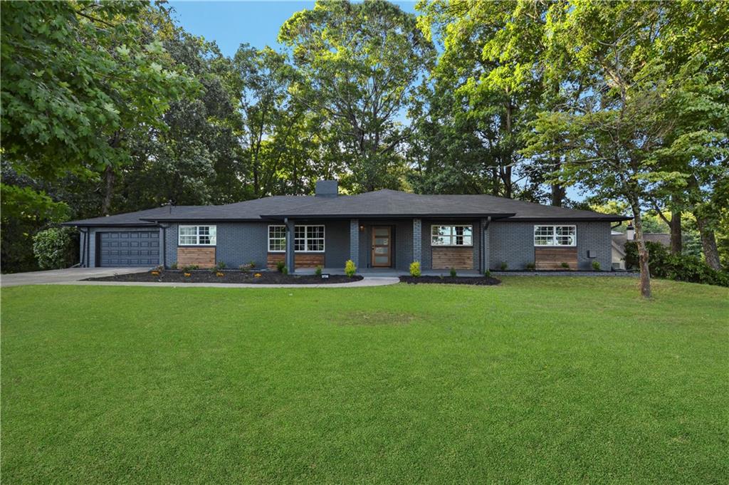 3738 Univeter Road Canton, GA 30115 - Photo 1 of 1 a view of a big yard with a large tree front of house