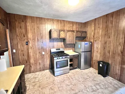 a kitchen with a stove and a refrigerator