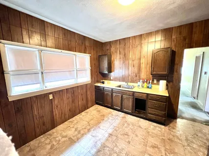 a kitchen with stainless steel appliances kitchen island granite countertop a sink stove and cabinets