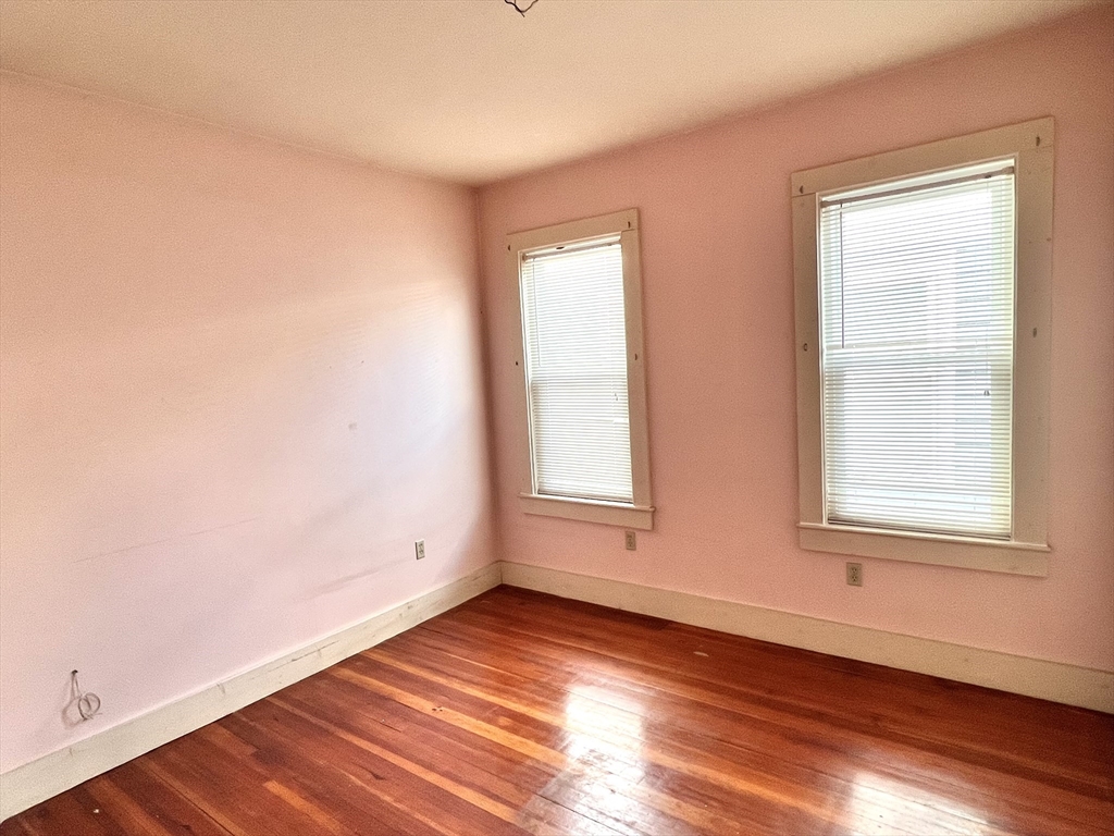 441 Winthrop Street Winthrop, MA 02152 - Photo 5 of 10 an empty room with wooden floor and windows