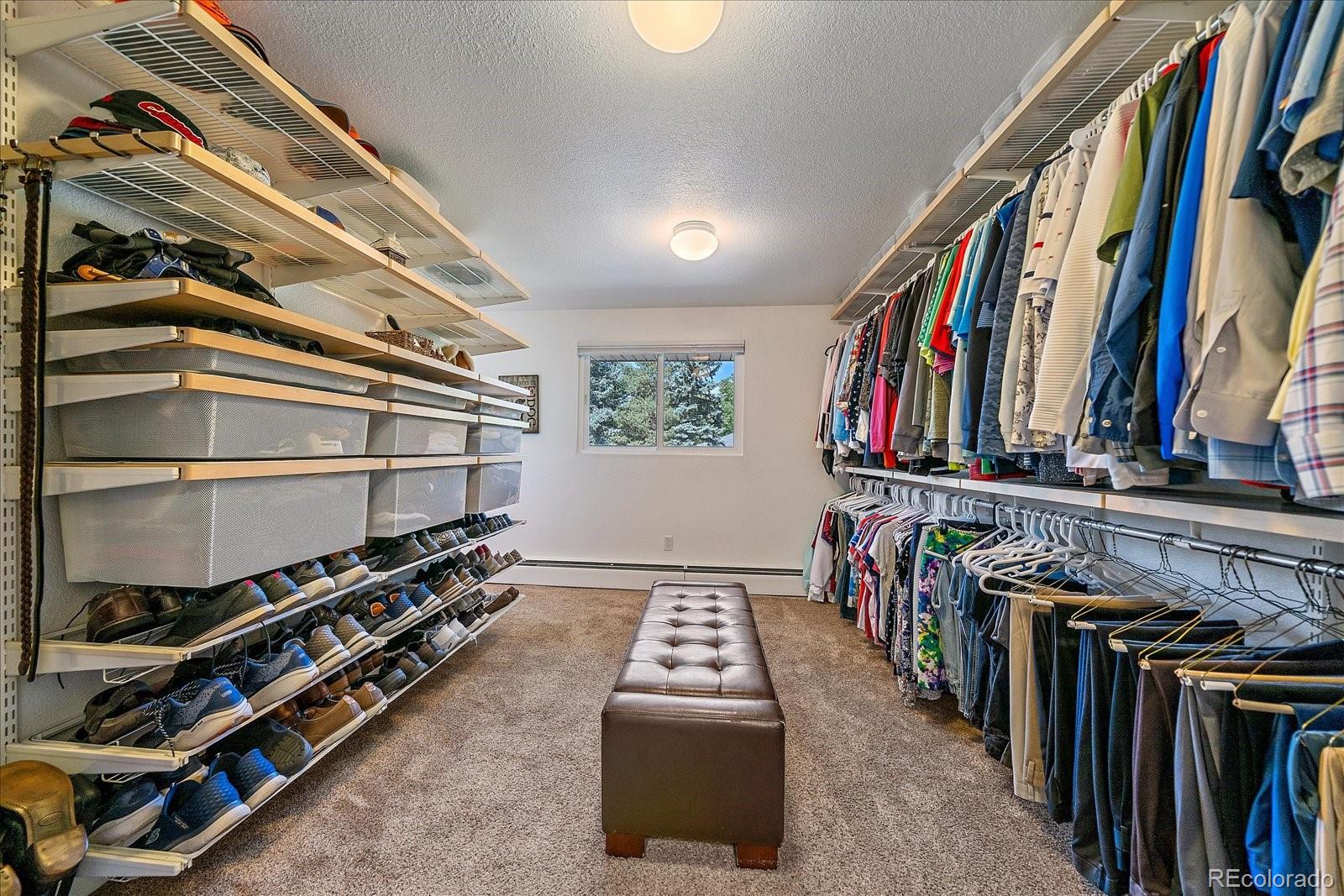 930 Reed Court Lakewood, CO 80214 - Photo 16 of 41 a view of walk in closet with clothes and shoes
