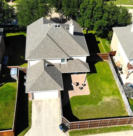 an aerial view of a house with a yard