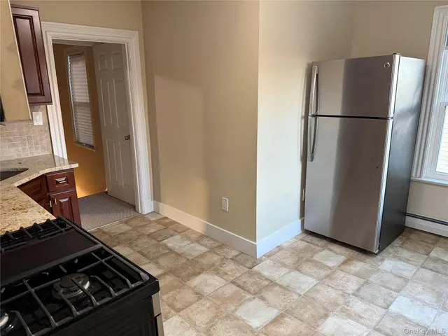 a kitchen with a refrigerator and a stove