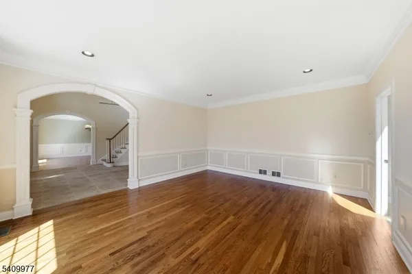 a view of a room with wooden floor