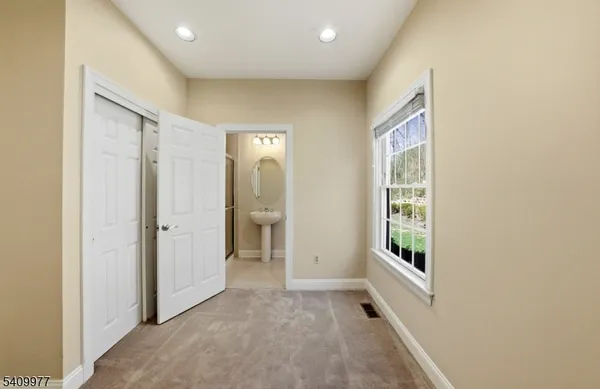 an empty room with windows and closet