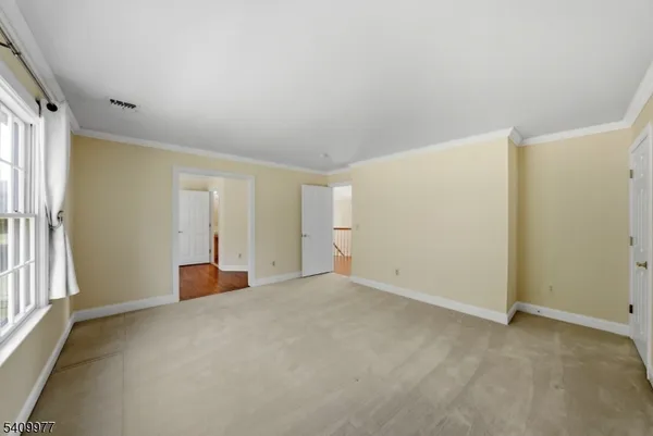 an empty room with windows and closet