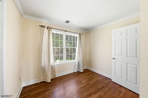 a view of hallway with wooden floor