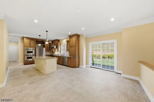a view of kitchen with furniture and refrigerator