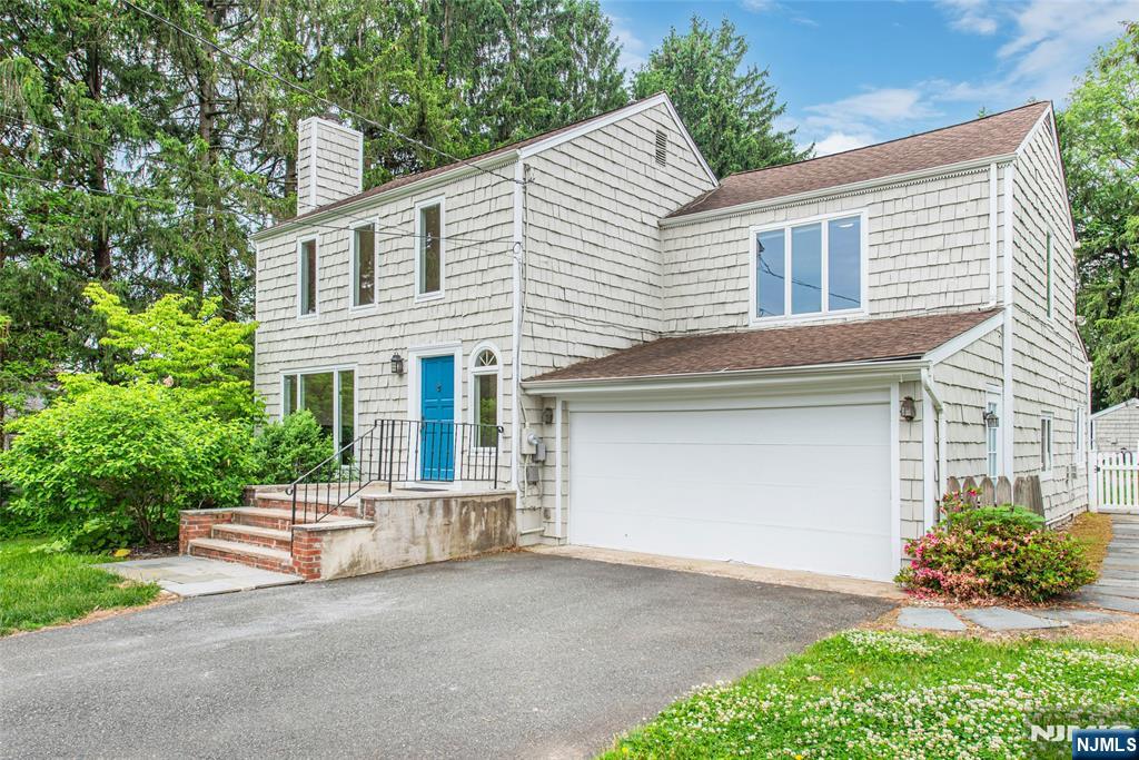 163 Sand Spring Road Morristown, NJ 07960 - Photo 3 of 39 a front view of a house with a garden