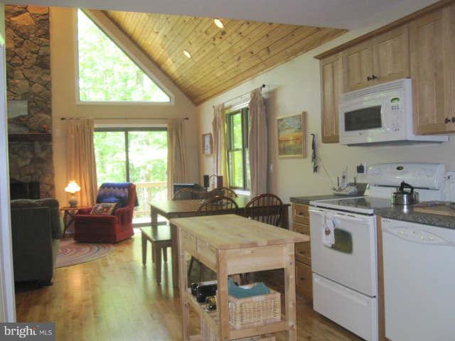 688 Fern Valley Way Springfield, WV 26763 - Photo 11 of 22 a kitchen with a stove a sink a dining table and chairs