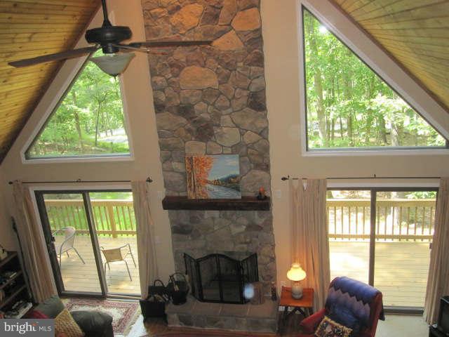 688 Fern Valley Way Springfield, WV 26763 - Photo 15 of 22 a living room with a fireplace and a large window