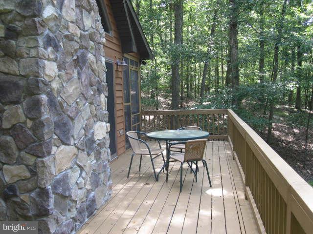 688 Fern Valley Way Springfield, WV 26763 - Photo 3 of 22 a balcony with wooden floor and outdoor seating