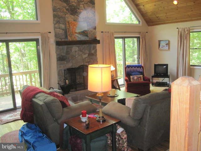688 Fern Valley Way Springfield, WV 26763 - Photo 5 of 22 a living room with furniture and a fireplace