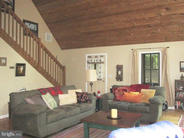 688 Fern Valley Way Springfield, WV 26763 - Photo 8 of 22 a living room with furniture and wooden floor