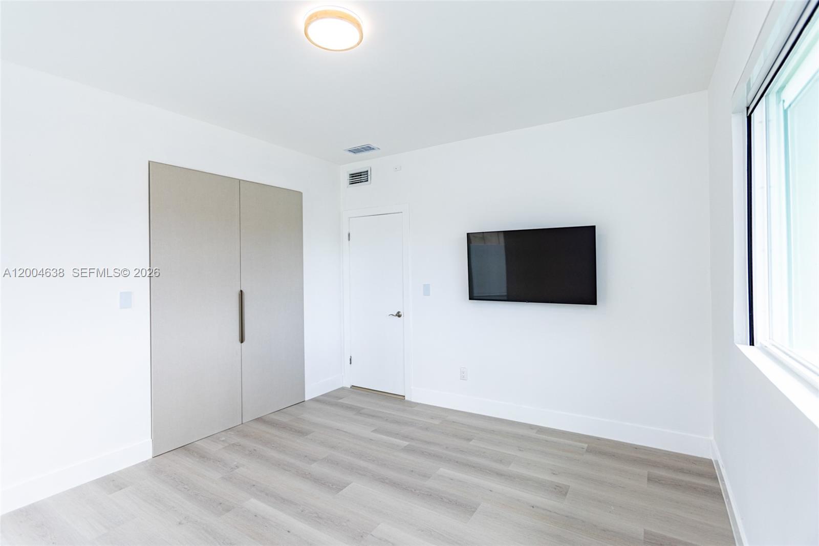 1690 Daytonia Road Miami Beach, FL 33141 - Photo 39 of 88 a view of a livingroom with wooden floor and a window